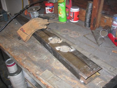 1989 Ford Bronco - A workbench is set up for metalworking, with a large steel beam as the central focus.
