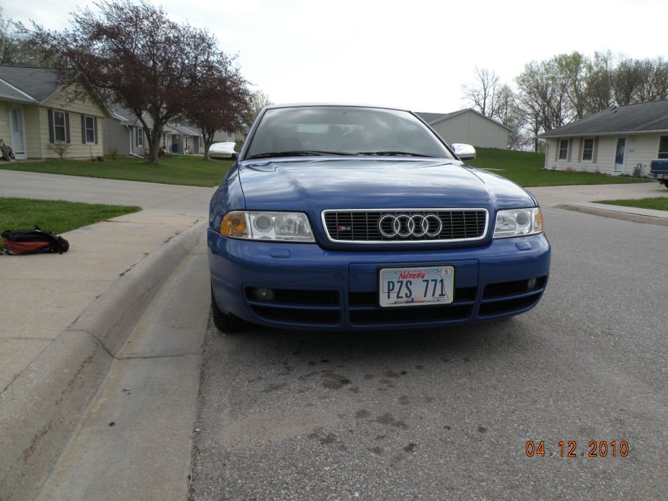 Blue 2001 Audi S4 sedan parked on street, front view. Nebraska license plate PZ5 771