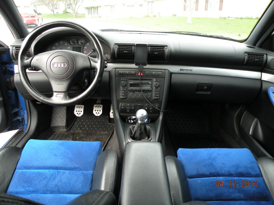 Audi interior with blue suede seat inserts, ball shift knob, aluminum pedals and iPod mount on black dash