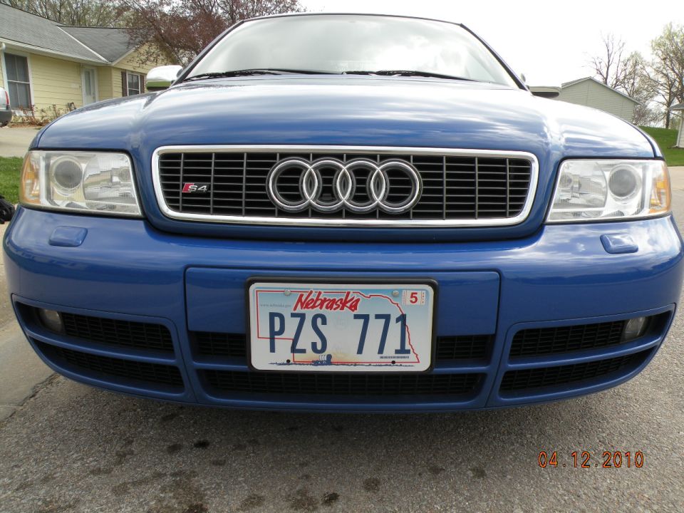Front of a bright blue Audi S4 with S4 grille badge and Nebraska PZS 771 plate