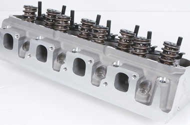 1973 Ford Ranchero - Close-up of an aluminum V8 engine cylinder head, showing the intake and exhaust ports and valve train components.