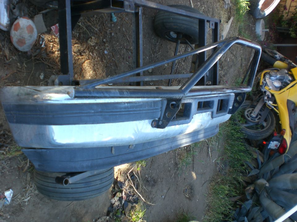 custom roll cage attached to a bumper, with a tire underneath