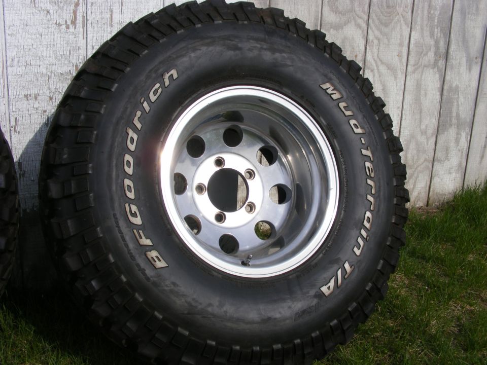 BFGoodrich Mud-Terrain T/A tire on polished aluminum five-lug wheel in grass