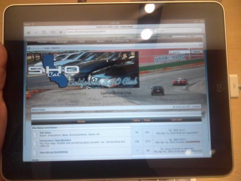 1993 Ford Taurus - A tablet displays the California SHO Club website, forum sections and a banner image of cars.