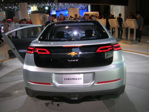 1996 Ford Bronco - Rear view of a silver Chevrolet Volt displayed at an auto show, with its doors open.