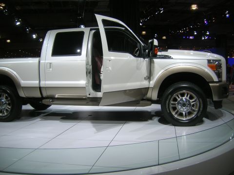 1996 Ford Bronco - A white and tan Ford F-Series truck is displayed with its doors open.