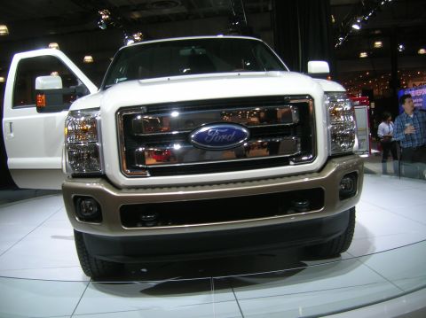 1996 Ford Bronco - White Ford F-Series truck on display with its driver's door open.