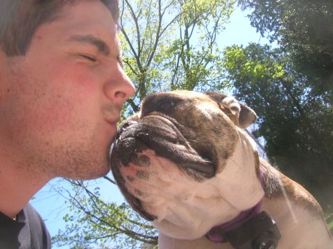 1996 Ford Bronco - A man shares a tender moment with his bulldog under a sunny sky.
