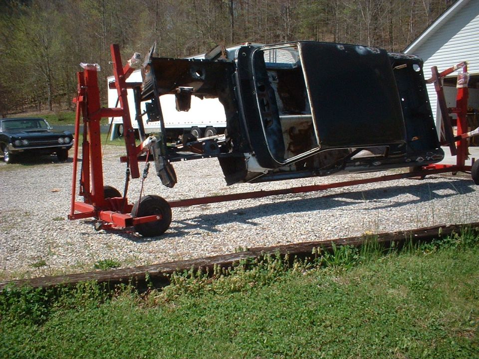 1964 Ford Fairlane body on a red rotisserie, another car in background