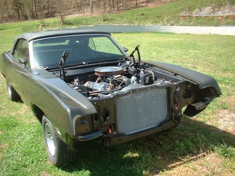1970 Ford Torino - 1970 Ford Torino convertible with its hood open, revealing the engine bay and radiator.