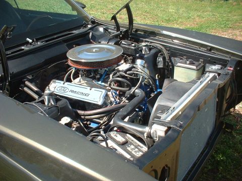 1970 Ford Torino - Engine bay view of a Ford V8 with Ford Racing valve covers and aftermarket air cleaner.