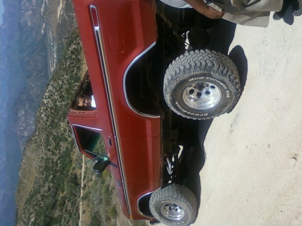 1978 Ford Bronco side view with off-road tires parked on dirt road