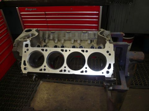 1975 Ford Ranchero - A bare engine block is secured in a vise, ready for work, with a red toolbox behind it.