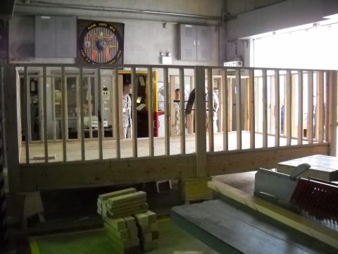 1986 Ford Bronco - Building interior with framing, lumber, and a Marine Corps emblem on the wall.
