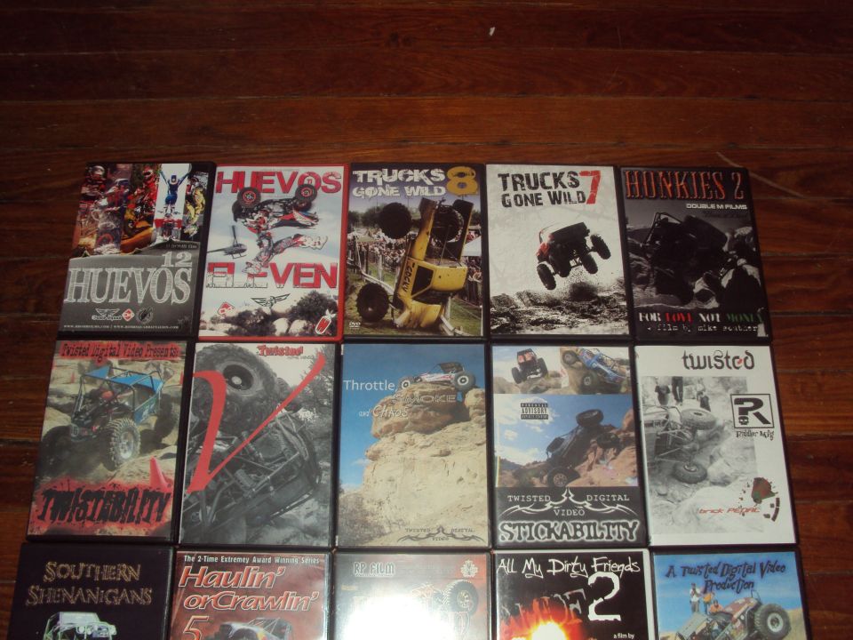 Collection of off-road vehicle DVDs on a wooden surface