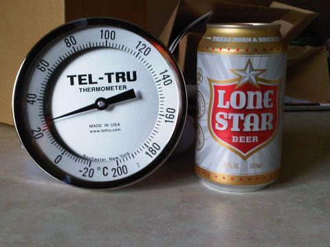 1992 Ford Bronco - A large chrome-bezel Tel-Tru dial thermometer, marked Made in USA and Rochester New York with a scale reading roughly 0 to 200 degrees, sta…