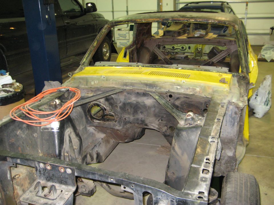 Yellow 1968 Mercury Cougar front end stripped for restoration