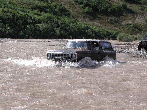 2002 Ford F-350 - Ford Bronco navigating a water crossing with another vehicle in the distance.