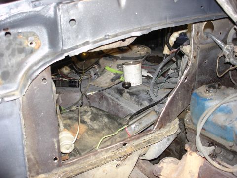 1979 Ford F-250 - The engine bay of a 1979 Ford F-250 shows exposed wiring and mechanical components, with a can of paint visible.