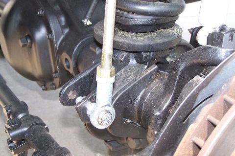 1990 Ford Bronco - Detail shot of a vehicle's suspension system, focusing on the axle and linkage.