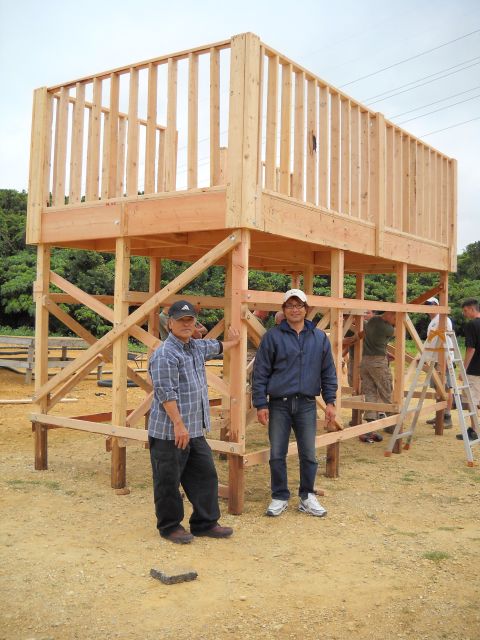 1986 Ford Bronco - Construction of a wooden structure, possibly a deck or observation platform, with several people involved.
