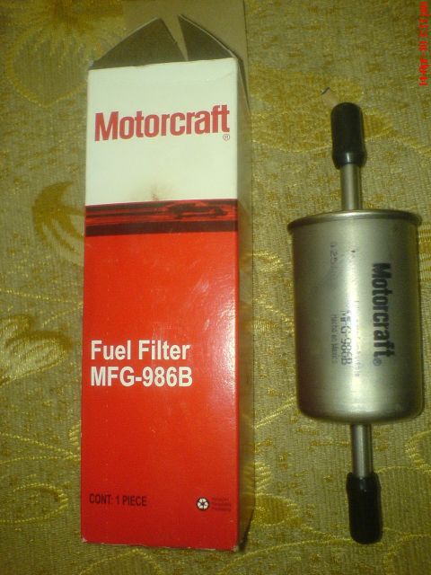 1998 Ford Crown Victoria - A Motorcraft fuel filter labeled MFG-986B is shown next to its packaging.