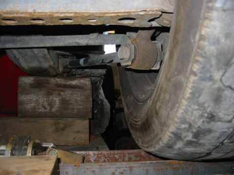 1993 Ford Taurus - Close-up view of a vehicle's underbody suspension and tire, supported by wooden blocks.