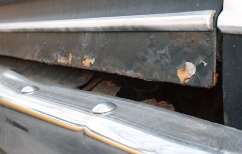 1979 Ford Bronco - Rusted metal panel and chrome trim detail, likely from an older vehicle.