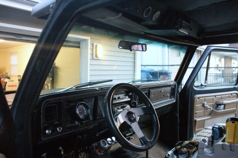 1979 Ford Bronco - Interior view of a 1979 Ford Bronco, an aftermarket steering wheel and additional gauges.
