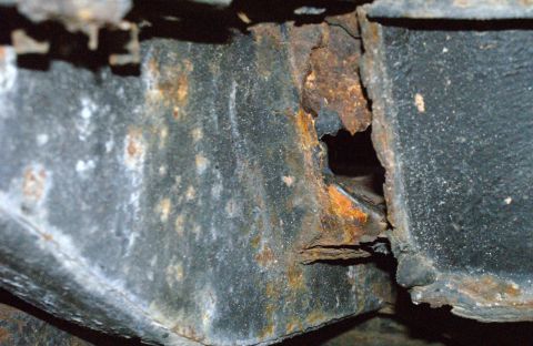 1979 Ford Bronco - Close-up of severely rusted metal frame, indicating significant corrosion damage.