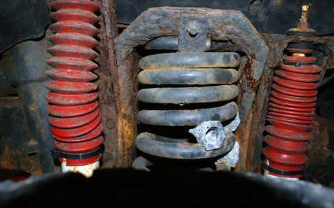 1979 Ford Bronco - Underside view of vehicle suspension system, showing coil springs and shock absorbers.