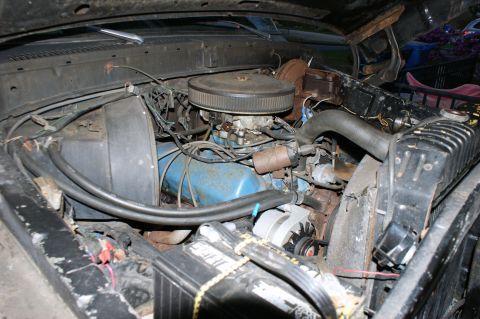 1979 Ford Bronco - The engine bay of a 1979 Ford Bronco is visible, with the V8 engine, radiator, and battery clearly depicted.