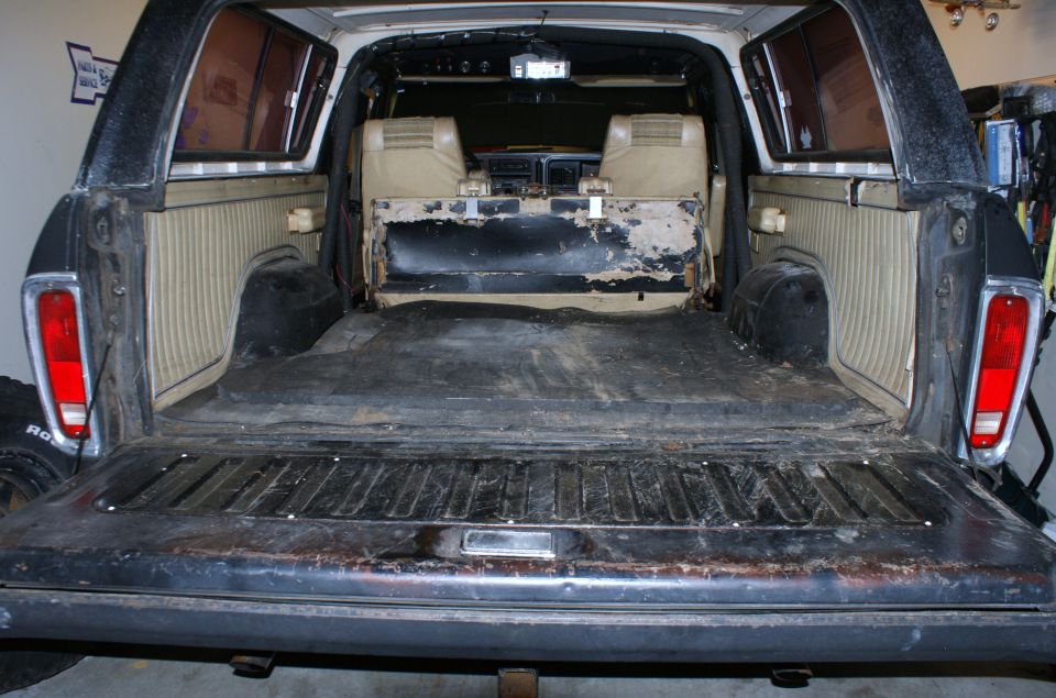 1979 Ford Bronco rear interior showing worn seats and cargo area
