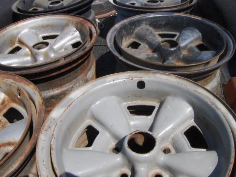 1980 Chevrolet Camaro - A collection of used car wheels, showing signs of wear and rust, are piled up.