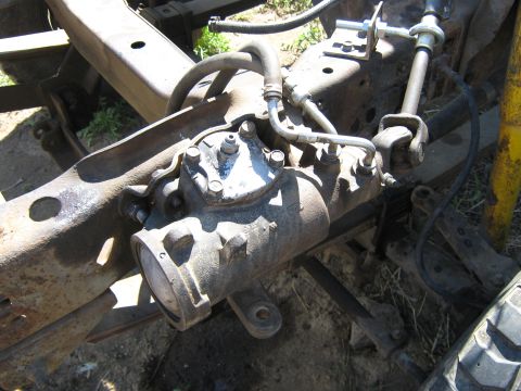 1972 Ford F-250 - Steering gear box assembly on a vehicle frame, showing hydraulic lines and mechanical linkage.