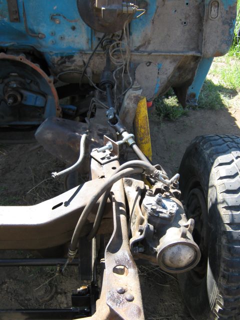 1972 Ford F-250 - Close-up view of the front chassis and steering mechanism of a disassembled truck.