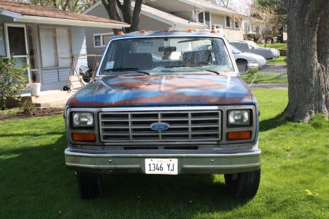 1985 Ford F-350 - This pickup truck has a weathered paint job and a prominent Ford grille. The license plate is visible.