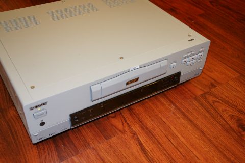 1993 Ford Taurus - A Sony DV-CAM video recorder sits on a wooden floor.