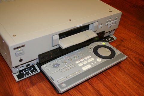 1993 Ford Taurus - Sony digital audio recorder and its remote control unit are placed on a wooden floor.
