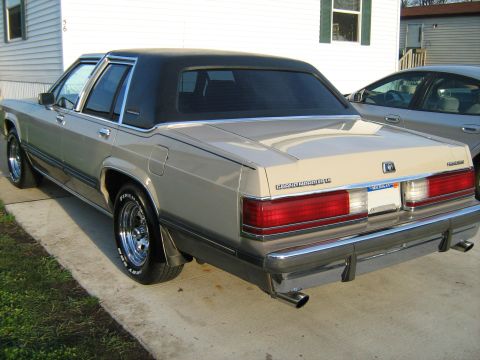 1988 Mercury Grand Marquis - The rear of a 1988 Mercury Grand Marquis is shown, parked next to another vehicle.