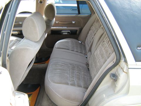 1988 Mercury Grand Marquis - The velour interior of a 1988 Mercury Grand Marquis, viewed from the rear passenger side.
