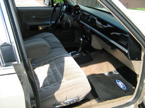 1988 Mercury Grand Marquis - Interior view of a 1988 Mercury Grand Marquis, plush seating and a Ford-branded floor mat.