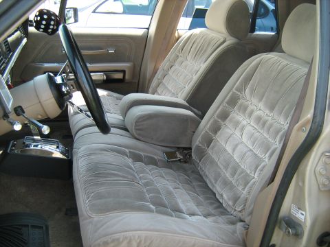 1988 Mercury Grand Marquis - The plush velour interior of a 1988 Mercury Grand Marquis, a column-mounted shifter and distinctive seat patterns.