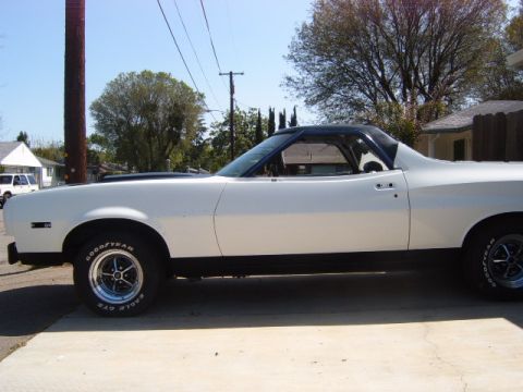 1973 Ford Ranchero - A white 1972 Ford Ranchero is parked on a concrete driveway under a clear blue sky.