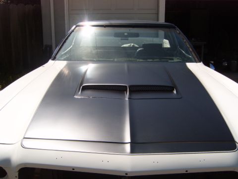 1973 Ford Ranchero - The front of a 1973 Ford Ranchero shows its hood with a matte black stripe and a functional scoop.