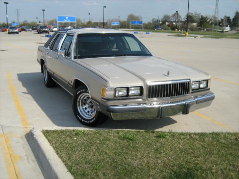 1988 Mercury Grand Marquis - A 1988 Mercury Grand Marquis is shown from the front three-quarter view in a parking lot.