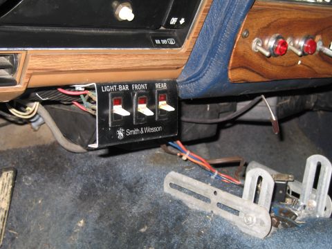 1991 Ford LTD Crown Victoria - Custom light bar switch panel with 'Smith & Wesson' branding is installed on the vehicle's interior dashboard.
