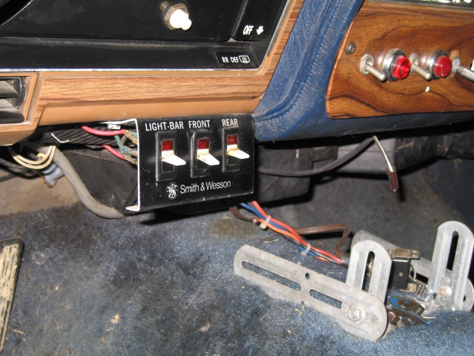 Interior dashboard with light bar switches labeled 'LIGHT-BAR FRONT REAR' and 'Smith & Wesson'