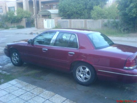 1998 Ford Crown Victoria - This maroon 1998 Ford Crown Victoria is seen from the rear quarter angle.