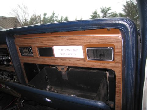 1991 Ford LTD Crown Victoria - Interior view of a car's dashboard, showing wood trim, air vents, and a seat belt reminder.